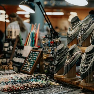 Beautiful display of artisan jewelry at an indoor market, showcasing necklaces and handcrafted beads.